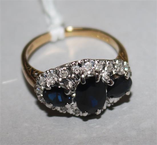 An 18ct gold, sapphire and diamond cluster ring, size M.
